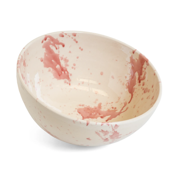 White ceramic bowl with pink speckles on a white background